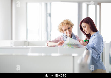 Businesswomen discussing in creative office Stock Photo