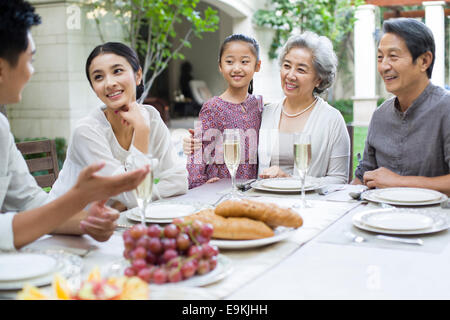 Family eating holiday meal together Stock Photo