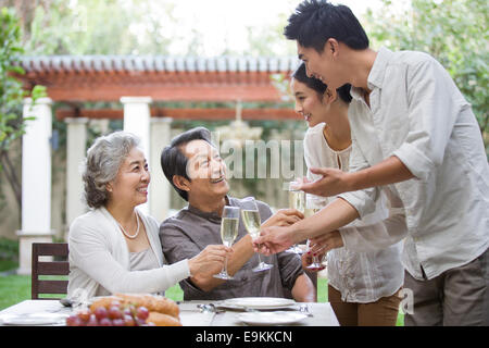 Happy family celebrating with champagne Stock Photo