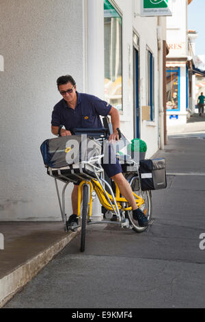 La Poste French postman on bicycle with outrigger stabilisers Stock Photo