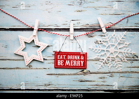 'Eat, drink and be merry' sign against a distressed wooden background Stock Photo