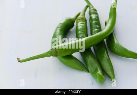 Green peppers on light blue wooden background Stock Photo