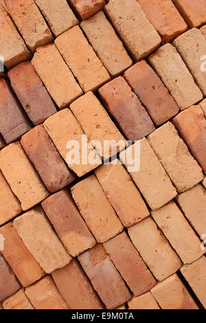 Handmade adobe bricks are stacked for sale at an outdoor brickyard in Cotacachi, Ecuador Stock Photo