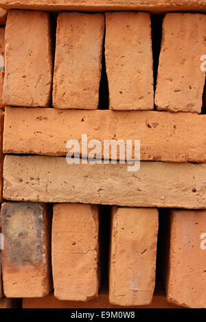Handmade adobe bricks are stacked for sale at an outdoor brickyard in Cotacachi, Ecuador Stock Photo