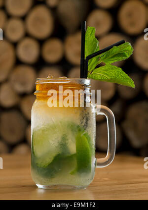 A mojito alcoholic cocktail served with mint, limes, sugar and rum in a bar. Stock Photo