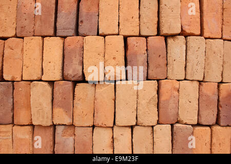 Handmade adobe bricks are stacked for sale at an outdoor brickyard in Cotacachi, Ecuador Stock Photo