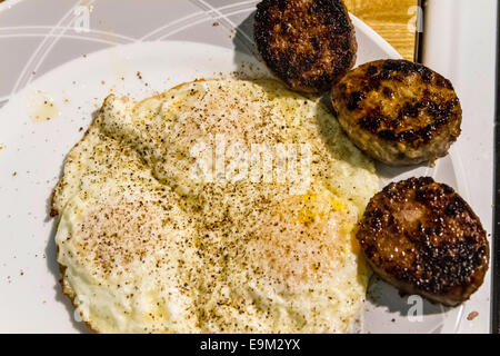 A hearty breakfast of sausage, eggs, and toast made from home made bread. Stock Photo