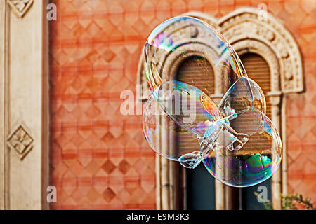 Giant soap bubbles on a background of historic building. Stock Photo