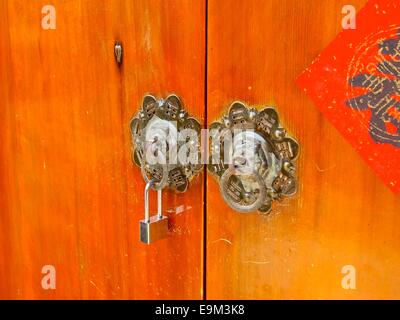 Ancient knockers and modern lock closeup in Taiwan Stock Photo