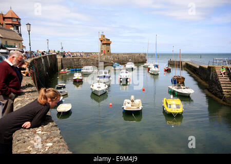 Looking over the wall at boats in Lynmouth Harbour in Devon Stock Photo