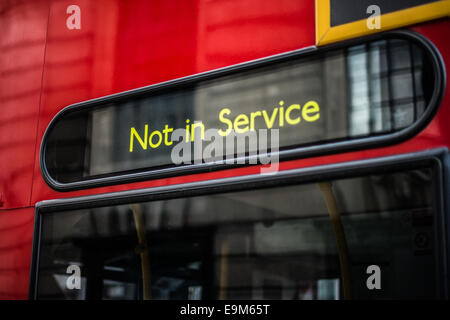 London Bus Not in Service Sign Close Up | LONDON, United Kingdom — A close-up of a red double-decker bus shows its destination blind reading "Not in Service." Modern buses use dot-matrix electronic displays that replaced hand-painted wooden roller blinds during the 1990s, letting drivers switch routes and out-of-service messages at the press of a button instead of manually cranking a physical scroll. Stock Photo