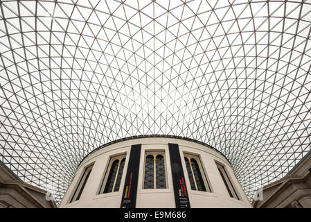 LONDON, United Kingdom — The Queen Elizabeth II Great Court at the British Museum. This expansive public square, designed by Foster and Partners, features a distinctive glass and steel roof made of 3,312 unique panes, and surrounds the historic Reading Room. Opened in 2000, it is the largest covered public square in Europe, serving as a central hub for visitors. Stock Photo