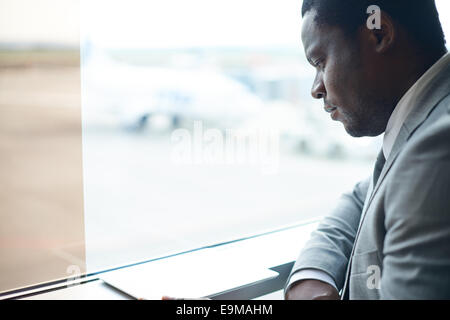 Serious Afro-American businessman using digital tablet Stock Photo