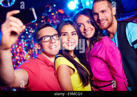Happy friends taking selfie at party Stock Photo