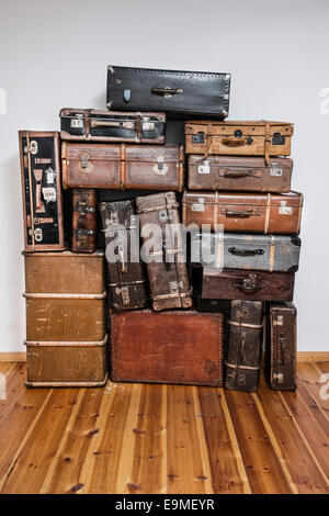 Old suitcases on hardwood floor Stock Photo