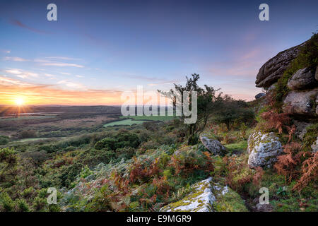 Beautiful Autumn sunrise over Helman Tor an outcrop of rugged granite moorland near Bodmin in Cornwall Stock Photo