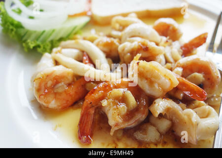 cooked shrimps and squid rings on a plate Stock Photo