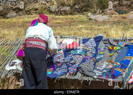 Man arranging the chullo hats on the display in Peru Stock Photo
