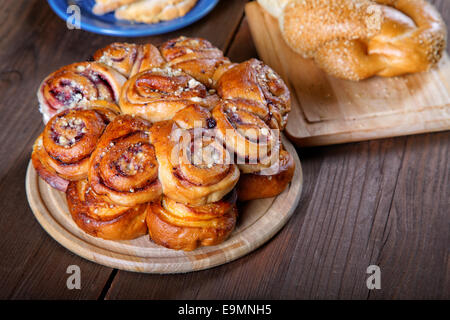 rolls and pies on a wooden table Stock Photo