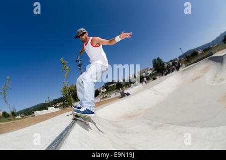 Skateboarder in a concrete pool Stock Photo