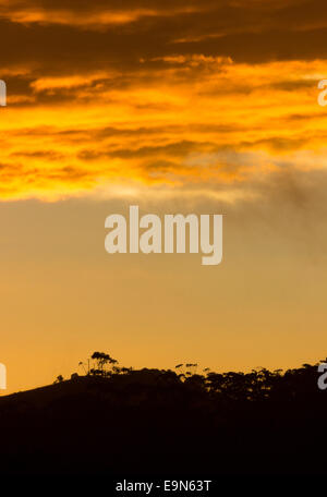 Sun breaking through clouds in rainstorm Stock Photo