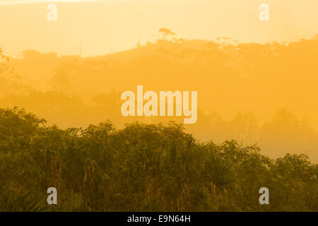 Sun breaking through clouds in rainstorm Stock Photo