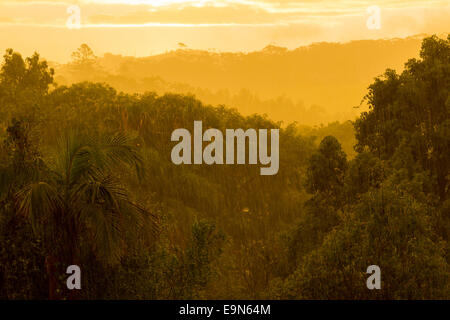 Sun breaking through clouds in rainstorm Stock Photo