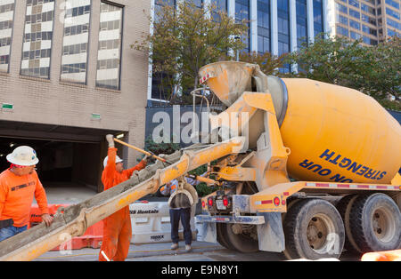 Municipal workers dumping concrete mix on roadside construction site - Arlington, Virginia USA Stock Photo