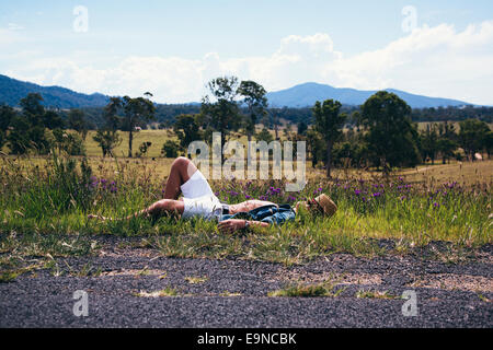 Young man lying in the grass, Australia Stock Photo