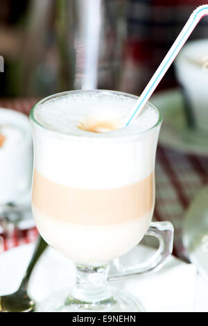 Layered cappuccino in a clear glass mug Stock Photo