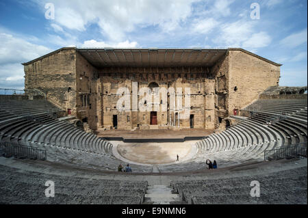 Tourists in auditorium and scaenae frons of the Roman Théâtre antique d'Orange / Ancient Theater of Orange, Vaucluse, France Stock Photo