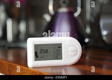 Close-up of a domestic electricity monitor in a kitchen showing a low level of energy consumption 2.58Kw Stock Photo