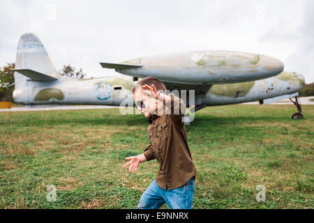 Little boy playing near the airplane Stock Photo
