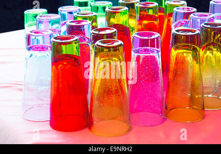 Beautiful colored glasses with the original invoice in the form of bubbles in the café on the surface of the table. Stock Photo