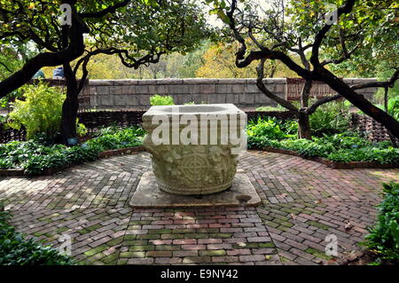 NYC: Handsome well with carved figures stands in the center of the 12th century Bonnefont's medieval herb garden