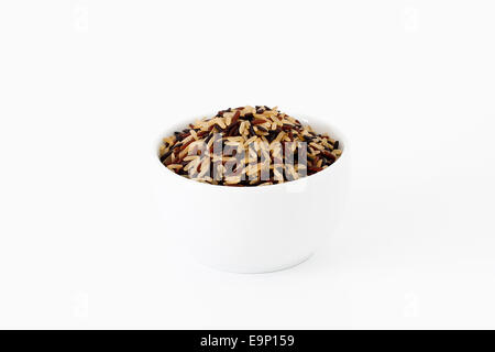 Brown, red and black rice mix in a bowl on white background Stock Photo