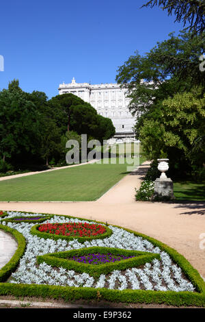 Flowers and flower bed in Campo de Moro gardens / Jardines del Palacio Real, Royal Palace behind, Madrid, Spain Stock Photo