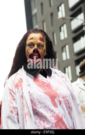 Participants walk around dressed as zombies and have zombie makeup at Montreal Zombie Walk 2014 edition Stock Photo