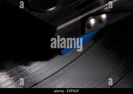 Close up magnification of a vinyl record playing on a turntable Stock Photo