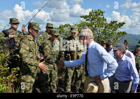 Meta, Colombia. 30th Oct, 2014. Image provided by Colombia's Presidency of Colombian President Juan Manuel Santos (R) and Prince Charles of Wales (Front) greeting soldiers during their visit to the military base of Cano Cristal, in the Macarena Hill, in Meta department, Colombia, on Oct. 30, 2014. Prince Charles of Wales, his wife Camilla, Duchess of Cornwall and the President Santos, travelled to the La Macarena Park to watch the labor of the country in the conservation of the environment. Credit:  Cesar Carrion/Colombia's Presidency/Xinhua/Alamy Live News Stock Photo