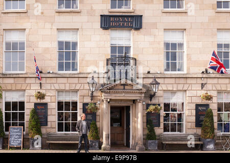 Man standing outside the Royal Hotel in Kirkby Lonsdale, a small market town in Cumbria, UK. Stock Photo