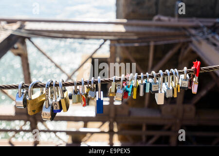 'Love locks' attached to a cable on Brooklyn Bridge, New York. USA. Stock Photo