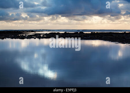 Morning Light Reflected in a Tide Pool at Robin Hoods Bay Yorkshire Coast England Stock Photo