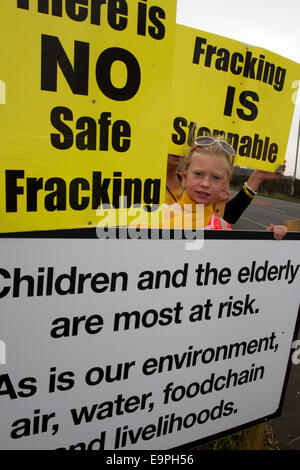 Blackpool, UK. 31st October, 2014. Frack Free Lancashire Paige Daniels 10 years old a Local Resident opposed to proposed fracking demonstrate in Fancy Dress outside Maple Farm Nursery. The area is filled with Anti-Fracking Signs erected & paid for by local businessman Mr John Toothill, who on his own admission is obsessive about his objection to proposed fracking at nearby Plumpton. Lancashire County Council is considering Cuadrilla’s planning application and they are encountering strong community resistance. Credit:  Mar Photographics/Alamy Live News Stock Photo