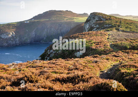 Sunshine at Pwll Deri with a view from the coast path towards the youth hostel and Garn Fawr. Stock Photo