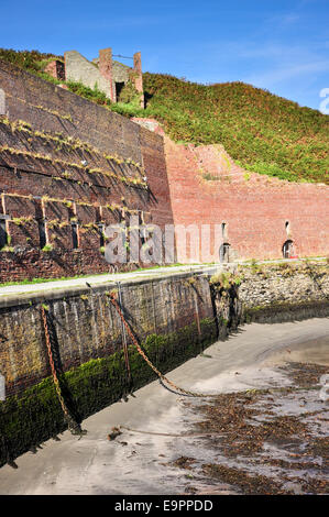 Porthgain harbour with remains of industrial buildings including red brick hoppers. Stock Photo