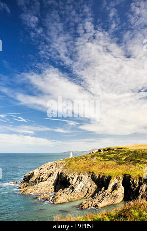 Beautiful sun bathed coastline at Porthgain in Pembrokeshire. A white beacon on the headland shows the entrance to the harbour. Stock Photo