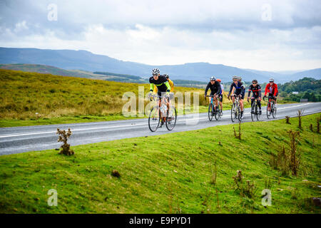 Group of cyclists on A4059 in the Brecon Beacons National Park Wales Stock Photo