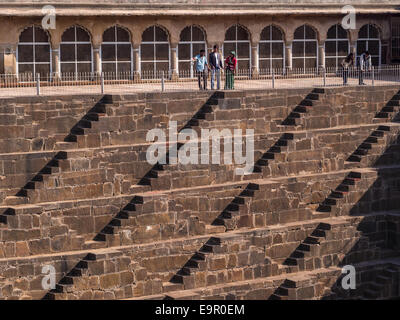 Tourists at the famous Chand Baori Stepwell in the village of Abhaneri, near Jaipur, Rajasthan, India. Stock Photo