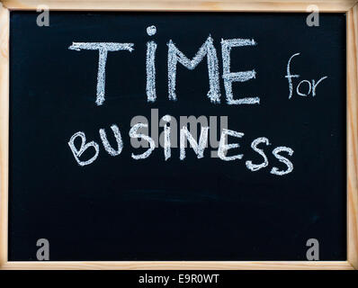 Time for business message handwritten with white chalk on wooden frame blackboard, successful business concept Stock Photo